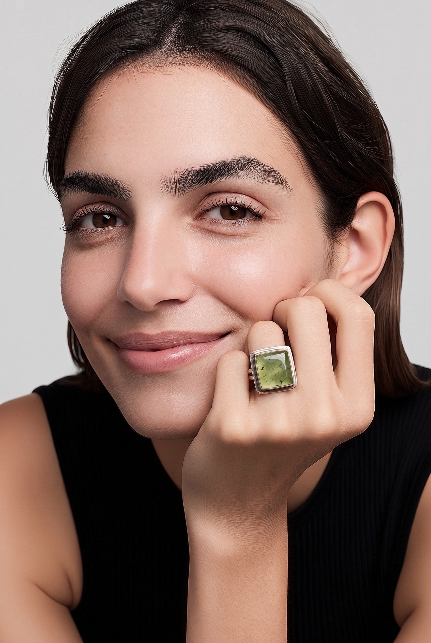 Woman wearing handmade prehnite and sterling silver square ring made by Ginny Taylor Designs -- artisan gemstone jewelry